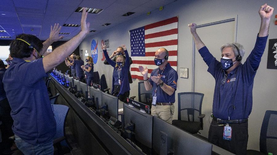 In this photo provided by NASA, members of NASA's Perseverance rover team react in mission control after receiving confirmation the spacecraft successfully touched down on Mars, Thursday, Feb. 18, 2021, at NASA's Jet Propulsion Laboratory in Pasadena, Calif. The landing of the six-wheeled vehicle marks the third visit to Mars in just over a week. Two spacecraft from the United Arab Emirates and China swung into orbit around the planet on successive days last week. (Bill Ingalls/NASA via AP)