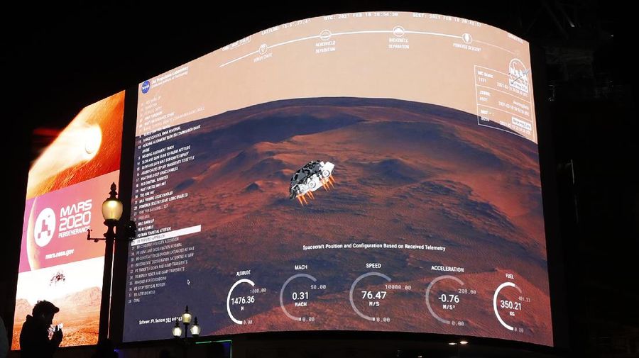 In this photo provided by NASA, members of NASA's Perseverance Mars rover team watch in mission control as the first images arrive moments after the spacecraft successfully touched down on Mars, Thursday, Feb. 18, 2021, at NASA's Jet Propulsion Laboratory in Pasadena, Calif. (Bill Ingalls/NASA via AP)