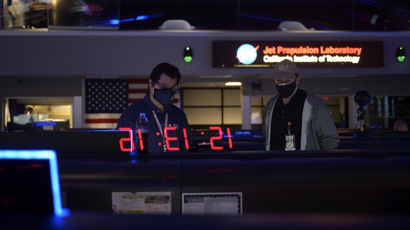 In this photo provided by NASA, members of NASA's Perseverance Mars rover team watch in mission control as the first images arrive moments after the spacecraft successfully touched down on Mars, Thursday, Feb. 18, 2021, at NASA's Jet Propulsion Laboratory in Pasadena, Calif. (Bill Ingalls/NASA via AP)
