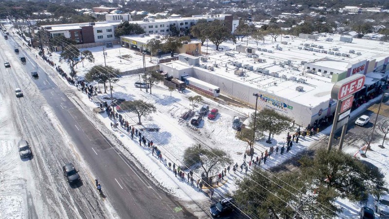 FILE - In this Feb. 16, 2021 file photo, People wait in a long line to buy groceries at H-E-B in Austin, Texas, during an extreme cold snap and widespread power outage. A series of winter storms and widespread power outages gripping Texas and other states not used to such extreme low temperatures are creating big challenges in the nation’s food supply networks. (Jay Janner/Austin American-Statesman via AP, File)