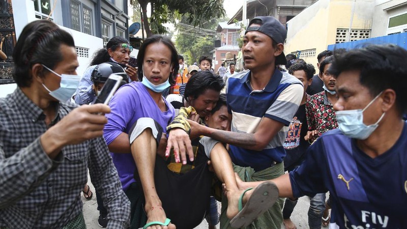 A police truck uses a water cannon to disperse protesters in Mandalay, Myanmar, on Saturday, Feb. 20, 2021. Security forces in Myanmar ratcheted up their pressure against anti-coup protesters Saturday, using water cannons, tear gas, slingshots and rubber bullets against demonstrators and striking dock workers in Mandalay, the nation's second-largest city. (AP Photos)