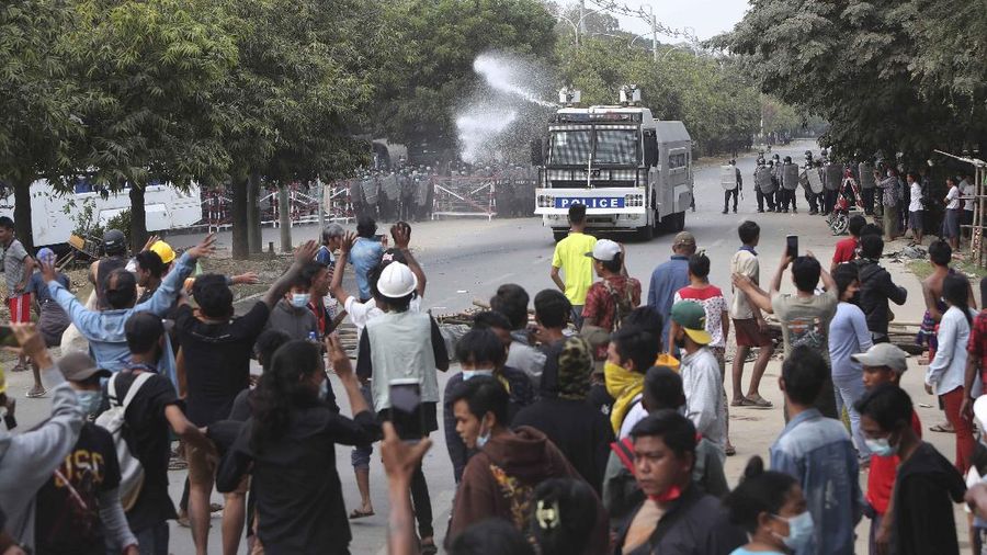 A police truck uses a water cannon to disperse protesters in Mandalay, Myanmar, on Saturday, Feb. 20, 2021. Security forces in Myanmar ratcheted up their pressure against anti-coup protesters Saturday, using water cannons, tear gas, slingshots and rubber bullets against demonstrators and striking dock workers in Mandalay, the nation's second-largest city. (AP Photos)