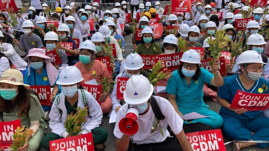 Students from the University of Medicine protest with brunches of Eugenia plants during an anti-coup protest in Mandalay, Myanmar, Sunday, Feb. 21, 2021. Police in Myanmar shot dead a few anti-coup protesters and injured several others on Saturday, as security forces increased pressure on popular revolt against the military takeover. (AP Photo)