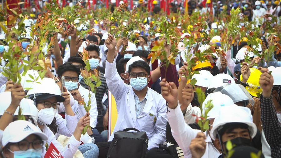 Students from the University of Medicine protest with brunches of Eugenia plants during an anti-coup protest in Mandalay, Myanmar, Sunday, Feb. 21, 2021. Police in Myanmar shot dead a few anti-coup protesters and injured several others on Saturday, as security forces increased pressure on popular revolt against the military takeover. (AP Photo)