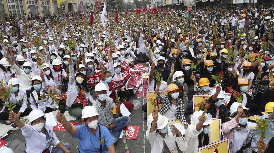 Students from the University of Medicine protest with brunches of Eugenia plants during an anti-coup protest in Mandalay, Myanmar, Sunday, Feb. 21, 2021. Police in Myanmar shot dead a few anti-coup protesters and injured several others on Saturday, as security forces increased pressure on popular revolt against the military takeover. (AP Photo)