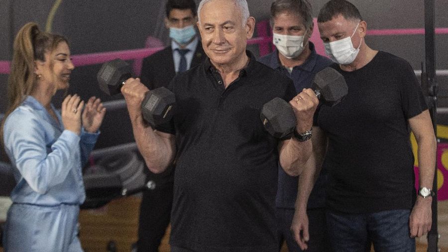 Israeli Prime Minister Benjamin Netanyahu and Health Minister Yuli Edelstein visits Fitness gym ahead of the re-opening of the branch in Petah Tikva, Israel on Saturday, Feb. 20, 2021. (AP Photo/Tal Shahar, Yediot Ahronot, Pool)