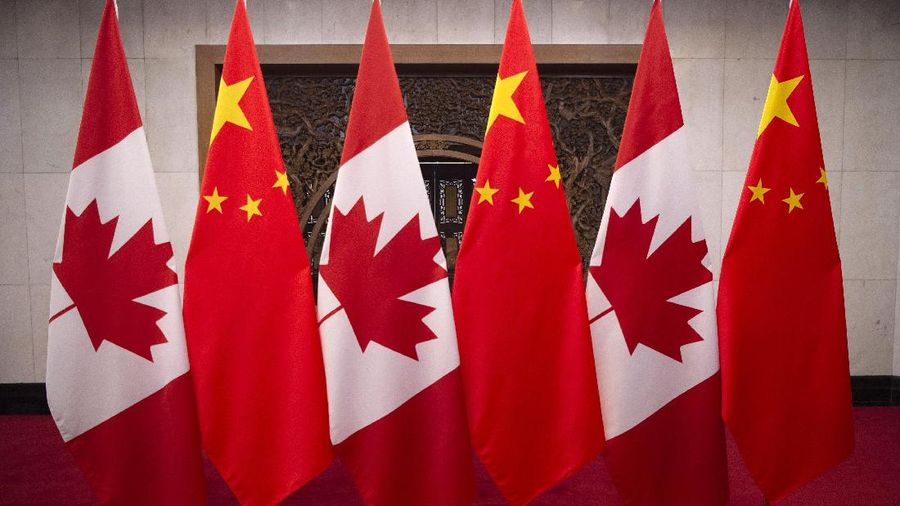 This Dec. 5, 2017, photo shows flags of Canada and China prior to a meeting of Canadian Prime Minister Justin Trudeau and Chinese President Xi Jinping at the Diaoyutai State Guesthouse in Beijing. (Fred Dufour/Pool Photo via AP)