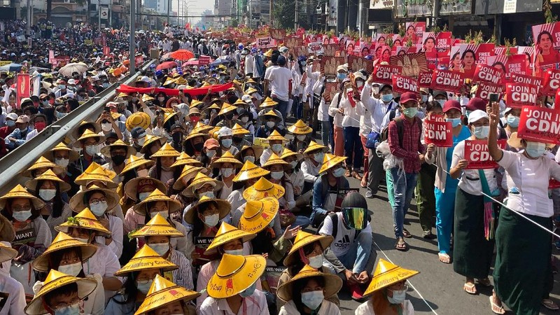 Anti-coup protesters fill the main road during a rally in Mandalay, Myanmar Monday, Feb. 22, 2021. A call for a Monday general strike by demonstrators in Myanmar protesting the military's seizure of power has been met by the ruling junta with a thinly veiled threat to use lethal force, raising the possibility of major clashes.(AP Photo)