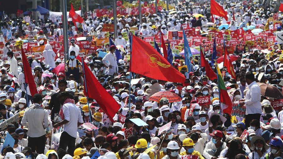 Anti-coup protesters fill up the road as they gather near the Mandalay Railway Station in Mandalay, Myanmar Monday, Feb. 22, 2021. A call for a Monday general strike by demonstrators in Myanmar protesting the military's seizure of power has been met by the ruling junta with a thinly veiled threat to use lethal force, raising the possibility of major clashes. (AP Photo)