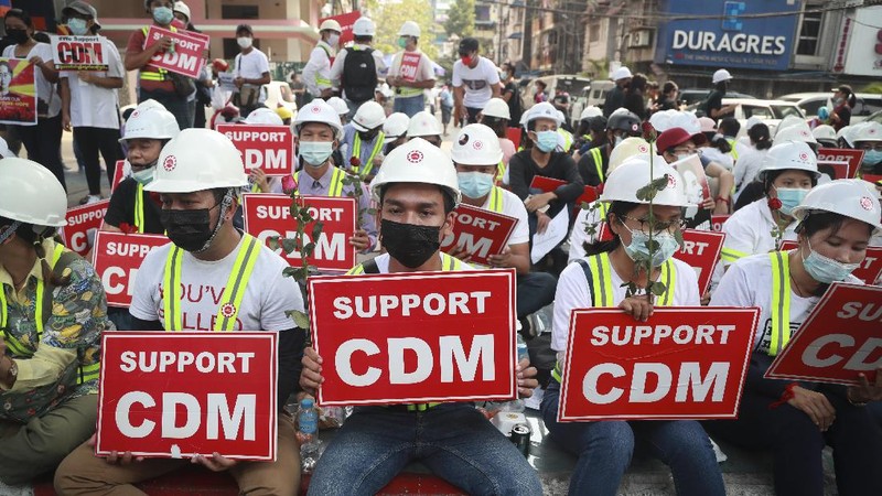 Anti-coup protesters fill the main road during a rally in Mandalay, Myanmar Monday, Feb. 22, 2021. A call for a Monday general strike by demonstrators in Myanmar protesting the military's seizure of power has been met by the ruling junta with a thinly veiled threat to use lethal force, raising the possibility of major clashes.(AP Photo)