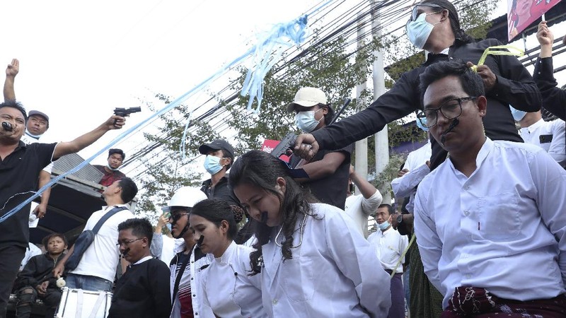 Anti-coup protesters fill the main road during a rally in Mandalay, Myanmar Monday, Feb. 22, 2021. A call for a Monday general strike by demonstrators in Myanmar protesting the military's seizure of power has been met by the ruling junta with a thinly veiled threat to use lethal force, raising the possibility of major clashes.(AP Photo)