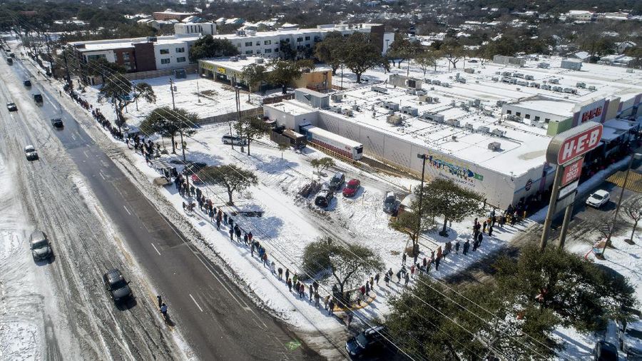 Volunteers load vehicles with food and water at a distribution site Monday, Feb. 22, 2021, in Houston. The city's boil water notice has been rescinded however many residents lack water at home due to broken pipes. (AP Photo/David J. Phillip)