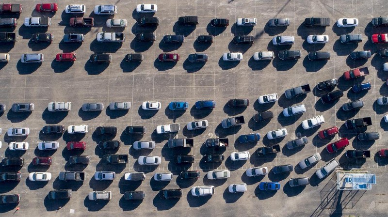 Volunteers load vehicles with food and water at a distribution site Monday, Feb. 22, 2021, in Houston. The city's boil water notice has been rescinded however many residents lack water at home due to broken pipes. (AP Photo/David J. Phillip)