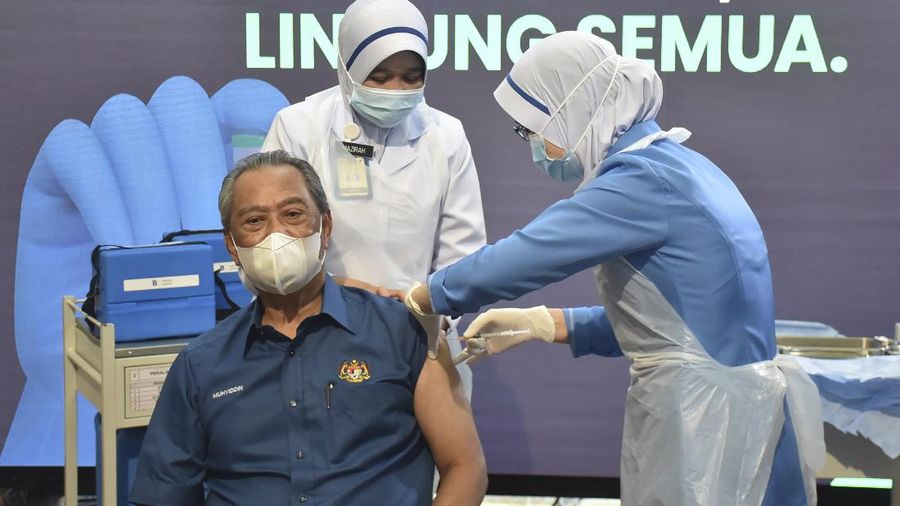 Malaysia's Prime Minister Muhyiddin Yassin receives the first dose of Pfizer-BioNTech COVID-19 vaccine at a clinic in Putrajaya, Malaysia, Wednesday, Feb. 24, 2021. (Malaysia Health Ministry via AP)
