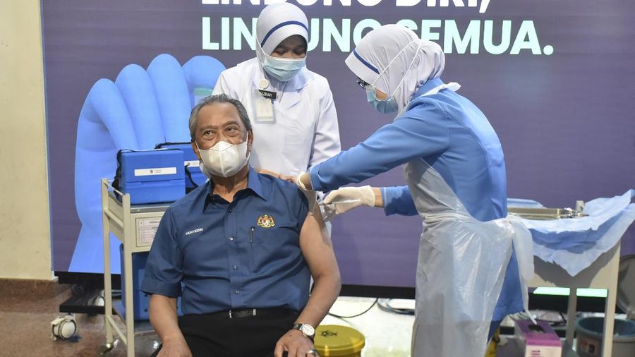 Malaysia's Prime Minister Muhyiddin Yassin receives the first dose of Pfizer-BioNTech COVID-19 vaccine at a clinic in Putrajaya, Malaysia, Wednesday, Feb. 24, 2021. (Malaysia Health Ministry via AP)