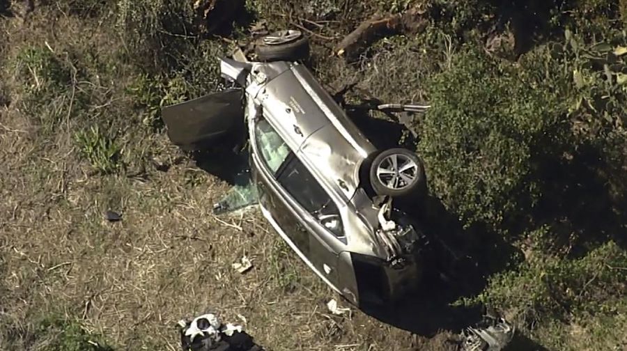 In this aerial image take from video provided by KABC-TV video, a vehicle rest on its side after a rollover accident involving golfer Tiger Woods along a road in the Rancho Palos Verdes suburb of Los Angeles on Tuesday, Feb. 23, 2021. Woods had to be extricated from the vehicle with the 