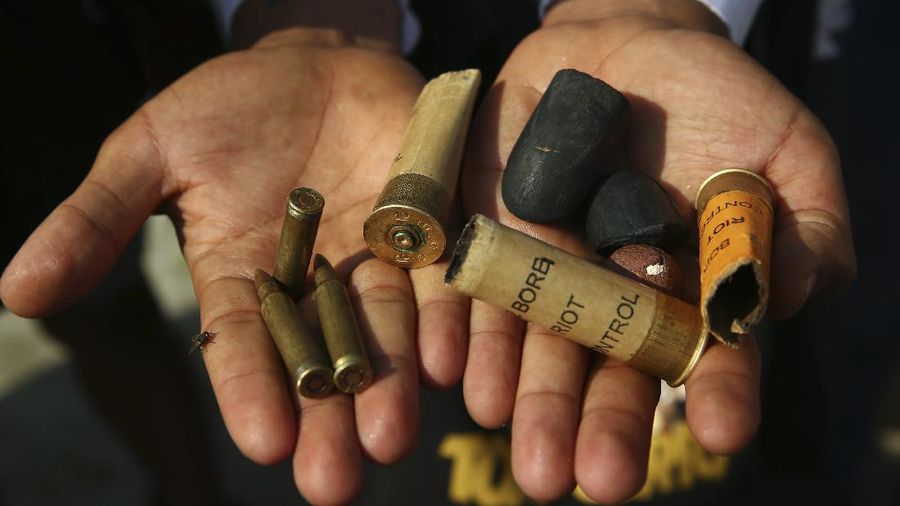 A protester show bullets, shotgun shells and rubber bullets used by security forces during a demonstration against the military coup in Mandalay, Myanmar, Friday, Feb. 26, 2021. (AP Photo)