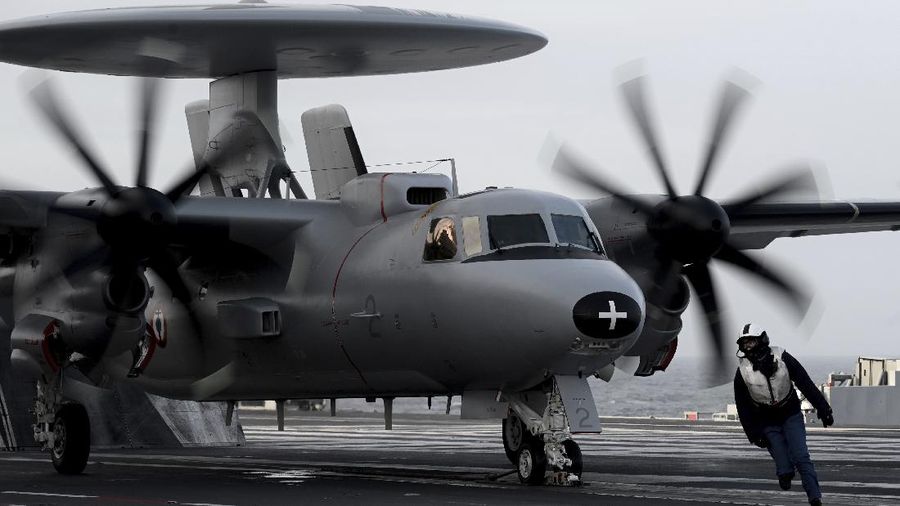 A military staff runs past an E-2 Hawkeye aircraft about to take off the French aircraft carrier Charles de Gaulle at sea, off the coast of the city of Hyeres on Thursday Jan. 23, 2020. ( Philippe Lopez, Pool via AP)
