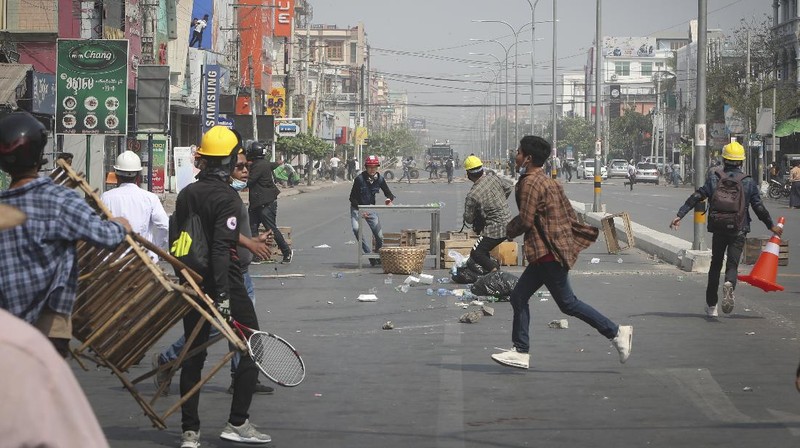 Protesters block a road during a protest against the military coup in Mandalay, Myanmar, Sunday, Feb. 28, 2021. Police in Myanmar escalated their crackdown on demonstrators against this month's military takeover, deploying early and in force on Saturday as protesters sought to assemble in the country's two biggest cities and elsewhere. (AP Photo)