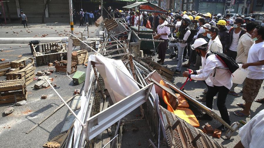 Protesters block a road during a protest against the military coup in Mandalay, Myanmar, Sunday, Feb. 28, 2021. Police in Myanmar escalated their crackdown on demonstrators against this month's military takeover, deploying early and in force on Saturday as protesters sought to assemble in the country's two biggest cities and elsewhere. (AP Photo)