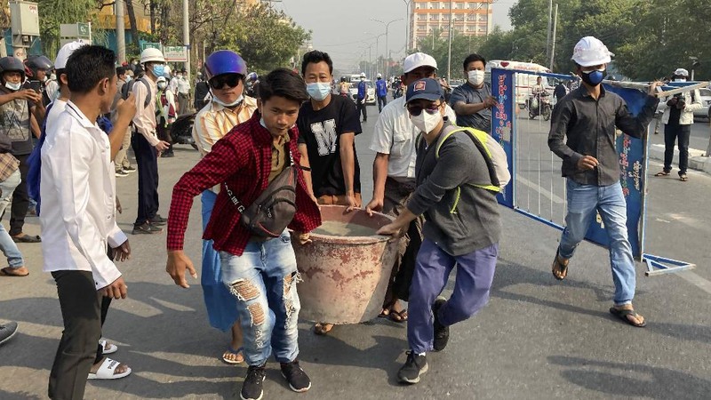 Protesters block a road during a protest against the military coup in Mandalay, Myanmar, Sunday, Feb. 28, 2021. Police in Myanmar escalated their crackdown on demonstrators against this month's military takeover, deploying early and in force on Saturday as protesters sought to assemble in the country's two biggest cities and elsewhere. (AP Photo)