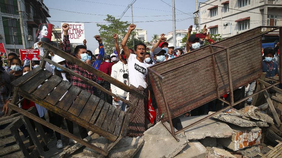 Protesters block a road during a protest against the military coup in Mandalay, Myanmar, Sunday, Feb. 28, 2021. Police in Myanmar escalated their crackdown on demonstrators against this month's military takeover, deploying early and in force on Saturday as protesters sought to assemble in the country's two biggest cities and elsewhere. (AP Photo)