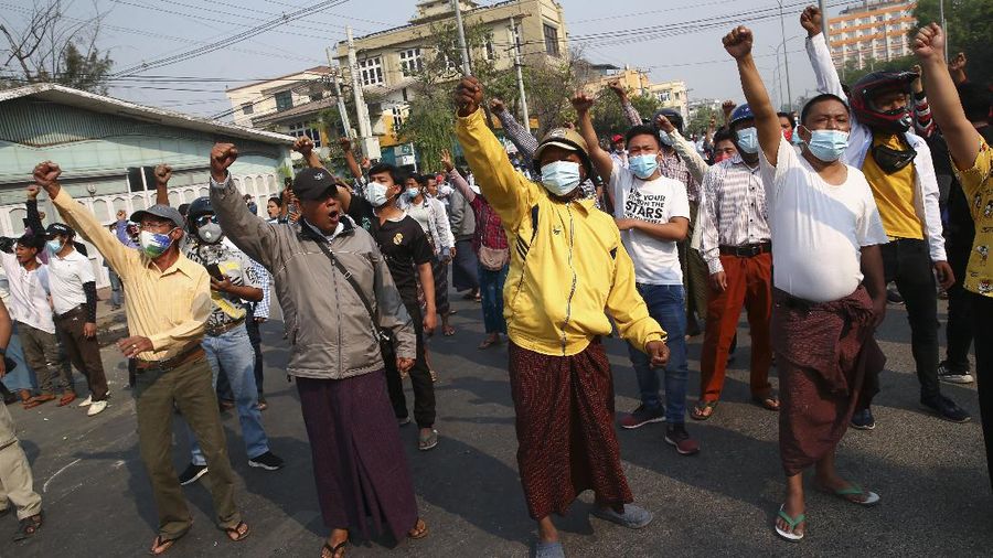 Protesters shout slogans as police arrive during a protest against the military coup in Mandalay, Myanmar, Sunday, Feb. 28, 2021. Police in Myanmar escalated their crackdown on demonstrators against this month's military takeover, deploying early and in force on Saturday as protesters sought to assemble in the country's two biggest cities and elsewhere. (AP Photo)