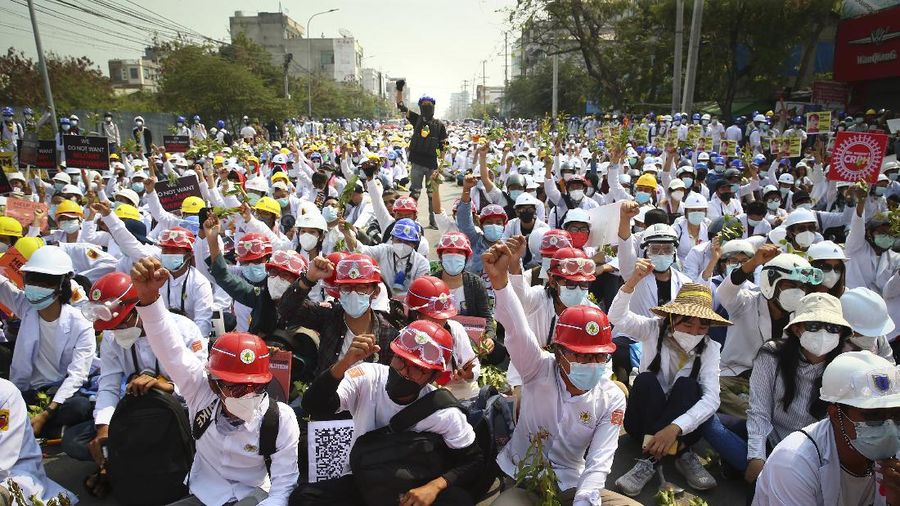 Protesters shout slogans during a protest against the military coup in Mandalay, Myanmar, Sunday, Feb. 28, 2021. Police fired tear gas and water cannons and there were reports of gunfire Sunday in Myanmar's largest city Yangon where another anti-coup protest was underway with scores of students and other demonstrators hauled away in police trucks. (AP Photo)