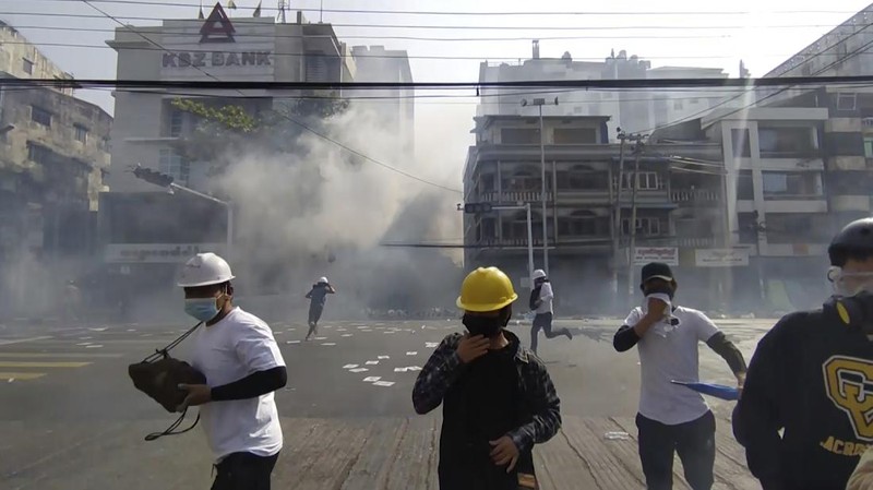 Protesters block a road during a protest against the military coup in Mandalay, Myanmar, Sunday, Feb. 28, 2021. Police in Myanmar escalated their crackdown on demonstrators against this month's military takeover, deploying early and in force on Saturday as protesters sought to assemble in the country's two biggest cities and elsewhere. (AP Photo)