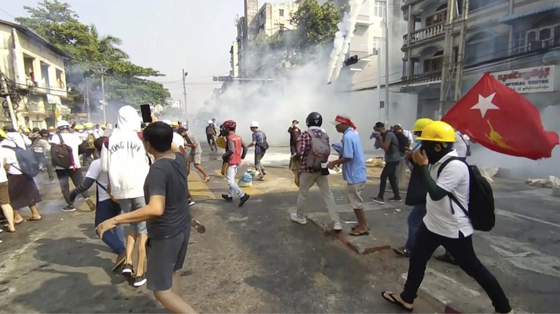 Protesters block a road during a protest against the military coup in Mandalay, Myanmar, Sunday, Feb. 28, 2021. Police in Myanmar escalated their crackdown on demonstrators against this month's military takeover, deploying early and in force on Saturday as protesters sought to assemble in the country's two biggest cities and elsewhere. (AP Photo)