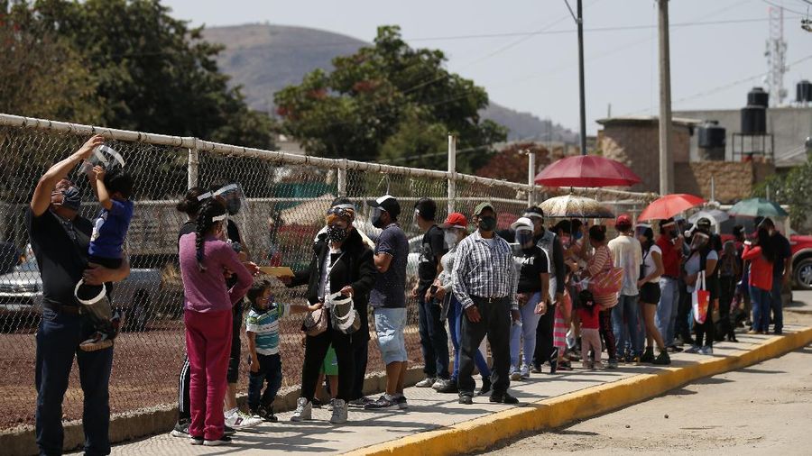 Officials and journalists ride in cable cars between the Campos Revolucion and Tlalpexco stations, during the inauguration of a new aerial public transit system dubbed the Cablebus, in the Cuautepec neighborhood of northern Mexico City, Thursday, March 4, 2021. For the residents of Cuautepec, this new system, the first of four planned lines, will turn a commute to the nearest subway station, that can last up to two hours, into a 30-minute ride. (AP Photo/Rebecca Blackwell)