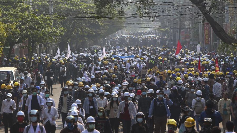 Protesters march on main road during an anti-coup demonstration in Mandalay, Myanmar, Sunday, March 7, 2021. The escalation of violence in Myanmar as authorities crack down on protests against the Feb. 1 coup is raising pressure for more sanctions against the junta, even as countries struggle over how to best sway military leaders inured to global condemnation. (AP Photo)