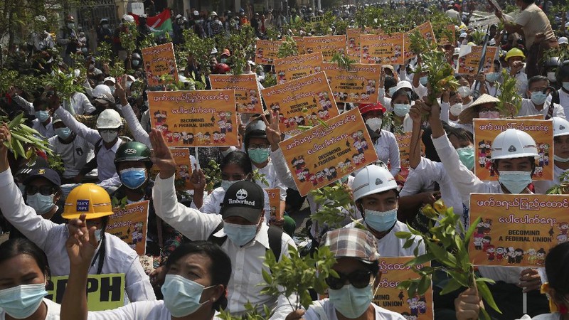 Riot police officers move in to disperse protesters during a demonstration in Yangon, Sunday, March 7, 2021. The escalation of violence in Myanmar as authorities crack down on protests against the Feb. 1 coup is raising pressure for more sanctions against the junta, even as countries struggle over how to best sway military leaders inured to global condemnation. (AP Photo)