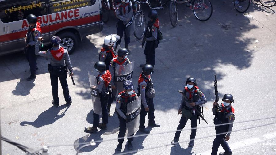 Riot police officers move in to disperse protesters during a demonstration in Yangon, Sunday, March 7, 2021. The escalation of violence in Myanmar as authorities crack down on protests against the Feb. 1 coup is raising pressure for more sanctions against the junta, even as countries struggle over how to best sway military leaders inured to global condemnation. (AP Photo)