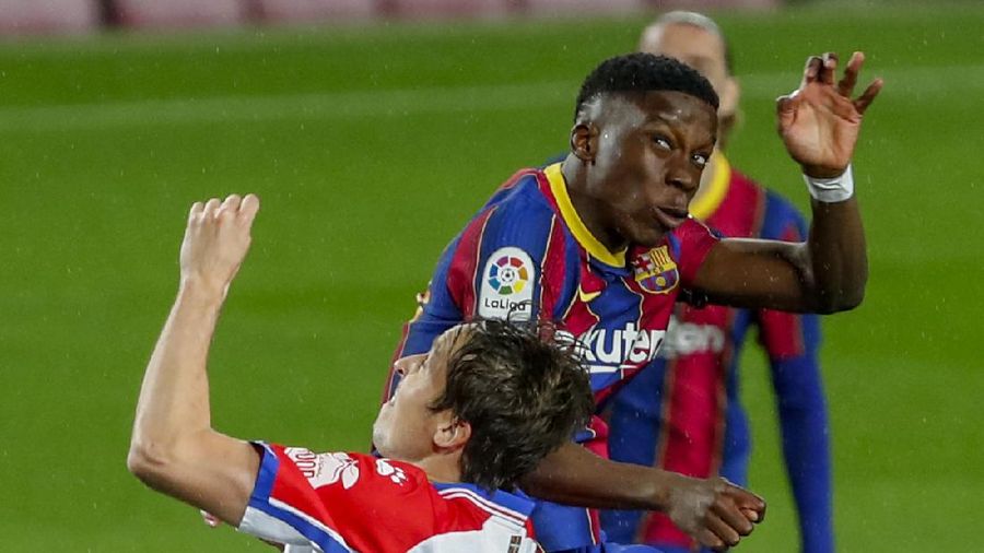 Alaves' Tomas Pina, left heads for the ball with Barcelona's Moriba Kourouma during the Spanish La Liga soccer match between FC Barcelona and Alaves at the Camp Nou stadium in Barcelona, Spain, Saturday, Feb. 13, 2021. (AP Photo/Joan Monfort)