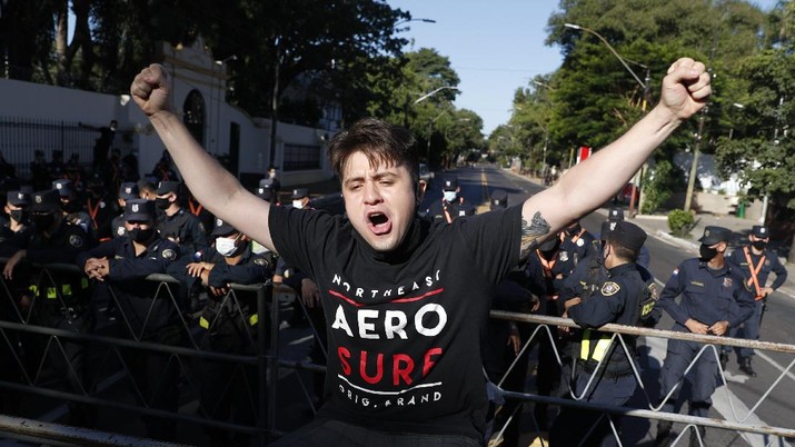 Para demonstran yang marah atas penanganan pemerintah Paraguay terhadap krisis virus korona (Covid-19), bentrok dengan polisi. (AP/Jorge Saenz)