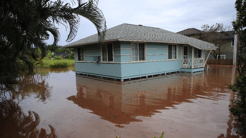 A house on Haleiwa Road is surrounded by floodwaters Tuesday, March 9, 2021, in Haleiwa, Hawaii. Torrential rains have inundated parts of Hawaii for the past several days. (Jamm Aquino/Honolulu Star-Advertiser via AP)