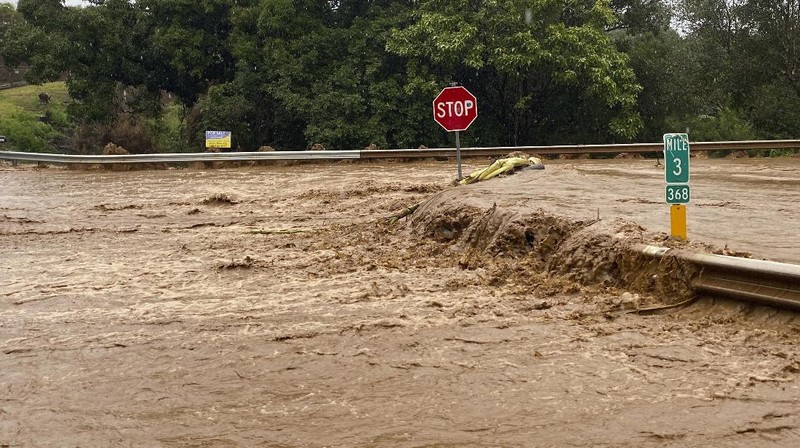 A house on Haleiwa Road is surrounded by floodwaters Tuesday, March 9, 2021, in Haleiwa, Hawaii. Torrential rains have inundated parts of Hawaii for the past several days. (Jamm Aquino/Honolulu Star-Advertiser via AP)