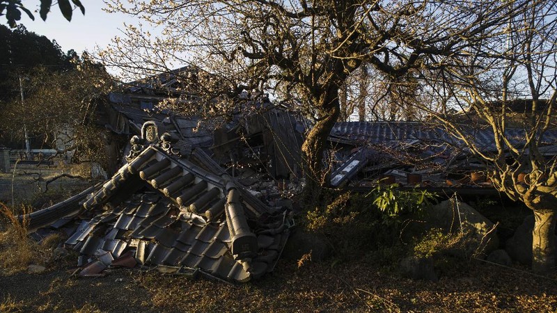 A statue stands surrounded by weeds at a park in the exlcusion zone in Tomioka town, Fukushima prefecture, northeastern Japan, Friday, Feb. 26, 2021. The no-go zone sits on its northeastern corner within about 10 kilometers (6 miles) of the wrecked Fukushima Daiichi nuclear power plant where massive radioactive fallouts spewed in 2011. (AP Photo/Hiro Komae)