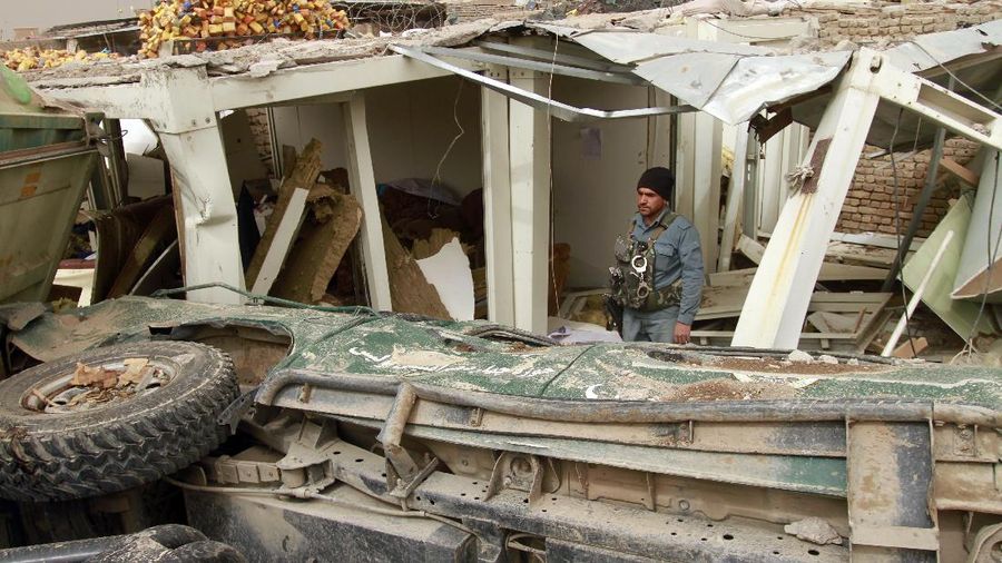 Locals inspect the site of a car bomb attack in Herat province, west of Kabul, Afghanistan, Saturday, March 13, 2021. A powerful car bomb killed numerous people and injured dozens more in Afghanistan's western Herat province, officials said Saturday. (AP Photo/Hamed Sarfarazi)