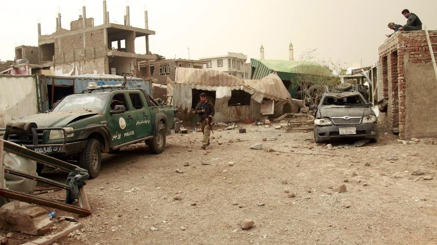 Locals inspect the site of a car bomb attack in Herat province, west of Kabul, Afghanistan, Saturday, March 13, 2021. A powerful car bomb killed numerous people and injured dozens more in Afghanistan's western Herat province, officials said Saturday. (AP Photo/Hamed Sarfarazi)