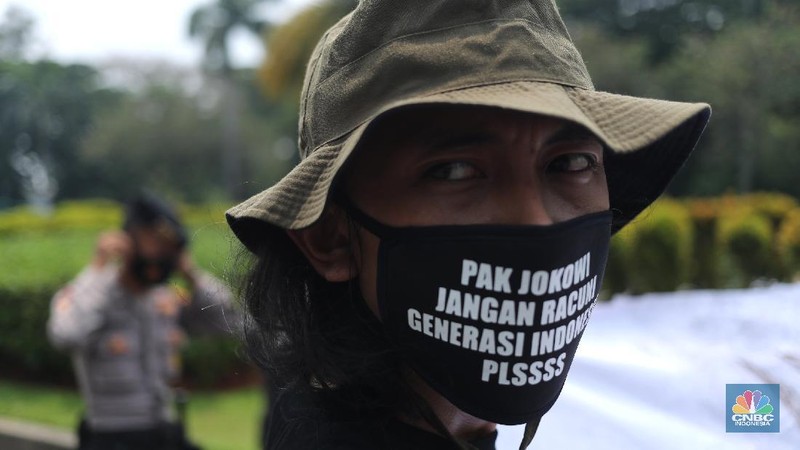 Sejumlah aktivis melakukan aksi simbolik menuntut Presiden Joko Widodo untuk mencabut Omnibus Law UU Cipta Kerja dan regulasi turunannya yang menghapus Fly Ash Bottom Ash (FABA) dari daftar limbah B3.di Kawasan Patung Kuda, Jakarta, 18 Maret 2021. (CNBC Indonesia/ Tri Susilo)