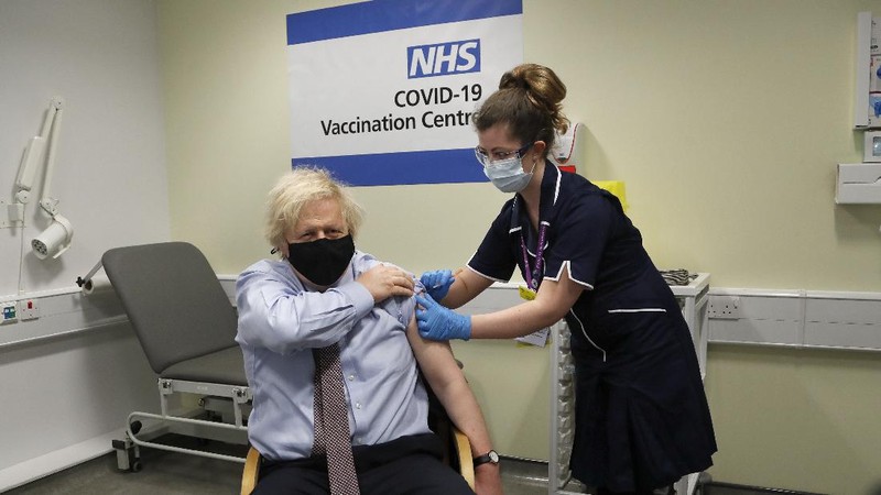 Britain's Prime Minister Boris Johnson receives the first dose of the AstraZeneca vaccine administered by nurse and Clinical Pod Lead, Lily Harrington at St. Thomas' Hospital in London, Friday, March 19, 2021. Johnson is one of several politicians across Europe, including French Prime Minister Jean Castex, getting a shot of the AstraZeneca vaccine on Friday. (AP Photo/Frank Augstein, Pool)