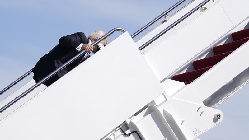 President Joe Biden recovers after stumbling while boarding Air Force One at Andrews Air Force Base, Md., Friday, March 19, 2021. Biden is en route to Georgia. (AP Photo/Patrick Semansky)