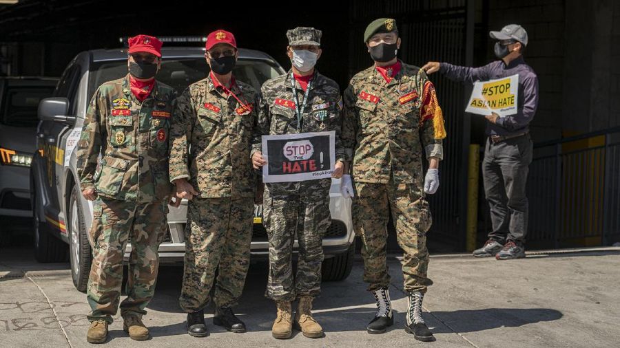 Members of the Korean American Federation of Los Angeles drive with signs reading: 