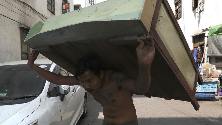 State railway employees load their belongings after being evicted from their home Saturday, March 20, 2021, in Mandalay, Myanmar. State railway workers in Mandalay have been threatened with eviction to force them to end their support for the Civil Disobedience Movement (CDM) against military rule. (AP Photo)