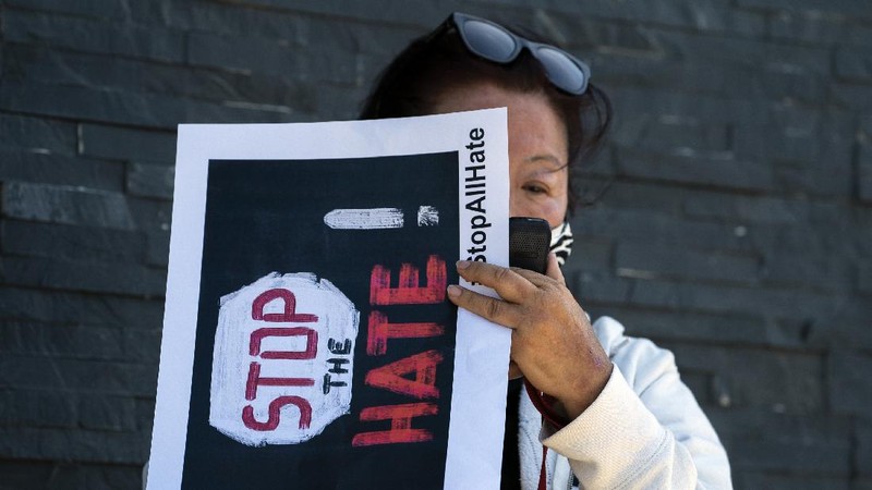 Members of the Korean American Federation of Los Angeles drive with signs reading: 