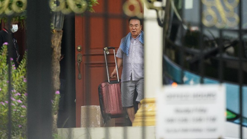 A bus carrying staffs of the North Korean embassy leaves the embassy compound in Kuala Lumpur, Sunday, March 21, 2021. Malaysia on Friday ordered all North Korean diplomats to leave the country within 48 hours, an escalation of a diplomatic spat over Malaysia's move to extradite a North Korean suspect to the United States on money laundering charges. (AP Photo/Vincent Thian)