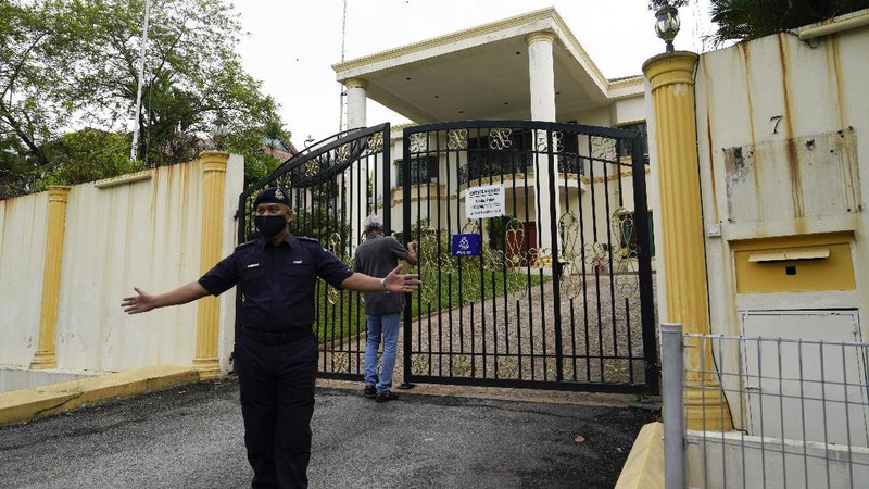 A bus carrying staffs of the North Korean embassy leaves the embassy compound in Kuala Lumpur, Sunday, March 21, 2021. Malaysia on Friday ordered all North Korean diplomats to leave the country within 48 hours, an escalation of a diplomatic spat over Malaysia's move to extradite a North Korean suspect to the United States on money laundering charges. (AP Photo/Vincent Thian)