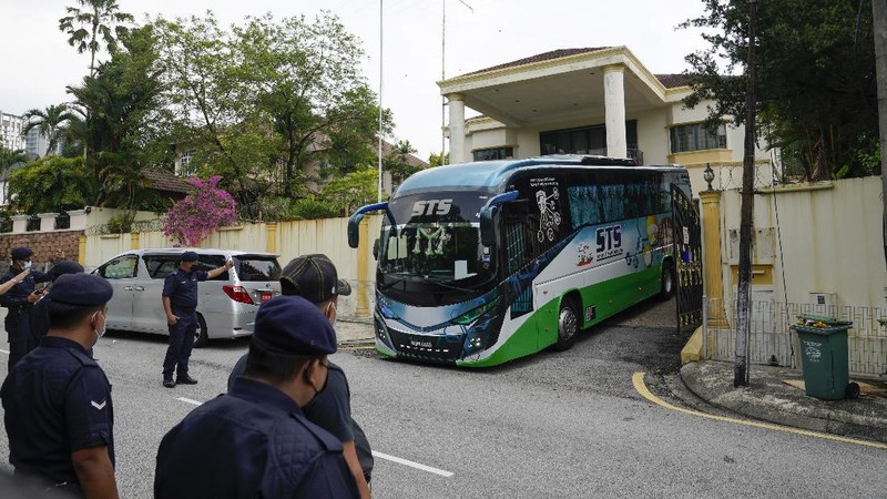 A bus carrying staffs of the North Korean embassy leaves the embassy compound in Kuala Lumpur, Sunday, March 21, 2021. Malaysia on Friday ordered all North Korean diplomats to leave the country within 48 hours, an escalation of a diplomatic spat over Malaysia's move to extradite a North Korean suspect to the United States on money laundering charges. (AP Photo/Vincent Thian)